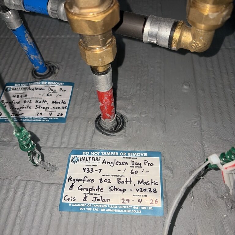 Batt and strap fire stopping around a PEX pipe in a riser