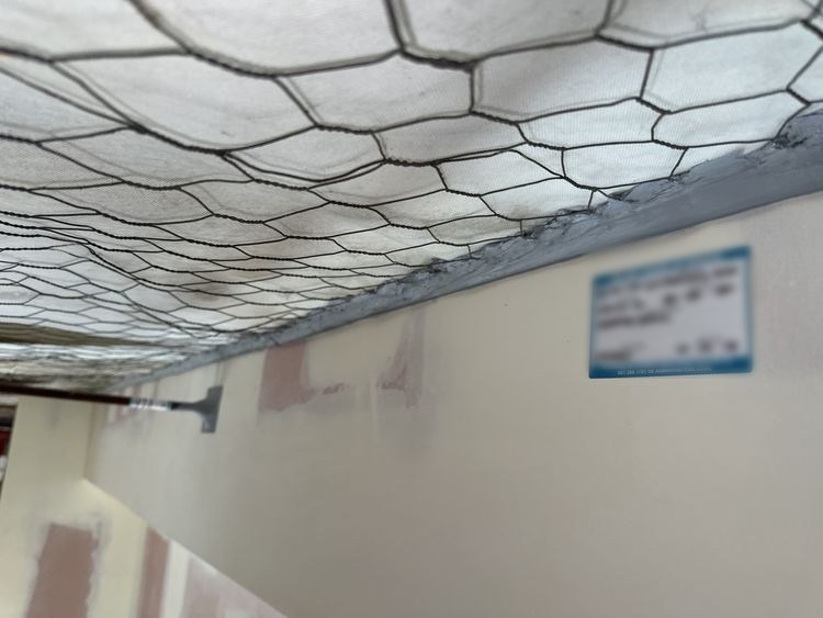Head-of-wall gap seal to the roof with compliance tag